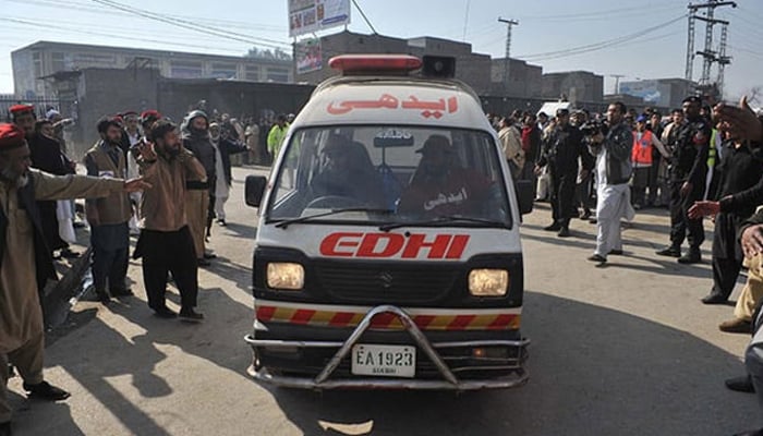 This representational image shows an ambulance arriving as surrounding people make their way. — AFP/File