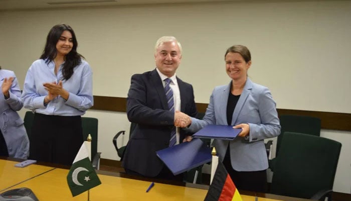 Officials from KfW Development Bank and Aga Khan Foundation shake hands after signing partnership agreement at the AKF office. — Supplied