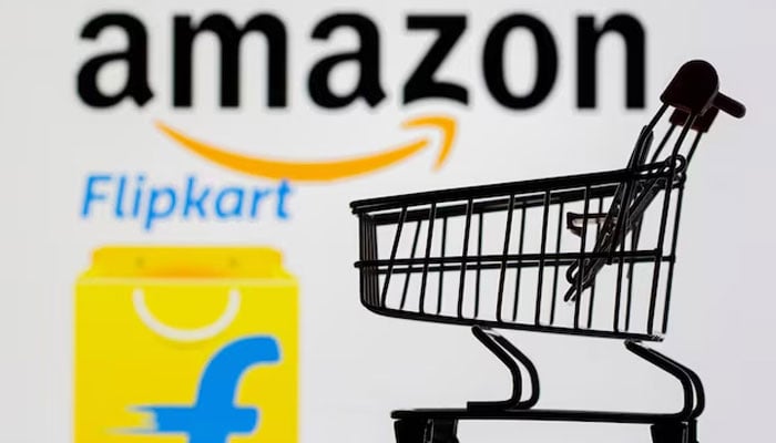 A small toy shopping cart is seen in front of displayed Amazon and Flipkart logos in this picture illustration taken, July 30, 2021. — Reuters