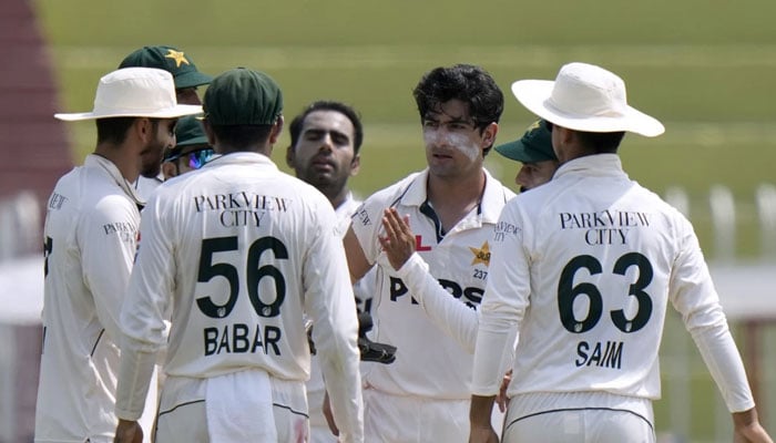 Pakistan Test cricket team players are discussing a matter during a match. — AFP/File