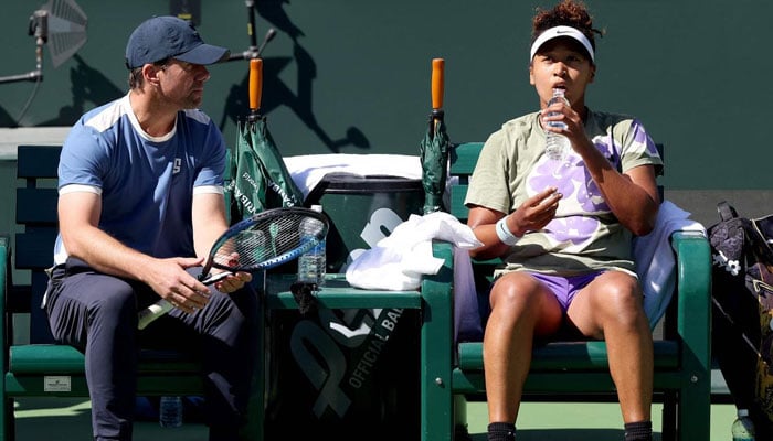 Naomi Osaka of Japan confers with coach Wim Fissette while training in preparation for the BNP Paribas Open at Indian Wells Tennis Garden on March 05, 2024 in Indian Wells, California. — AFP