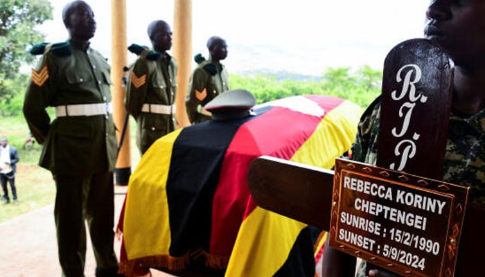 Soldiers from Uganda Peoples Defence Forces (UPDF) stand near the flag-draped coffin of the slain Ugandan Olympian Rebecca Cheptegei, before her burial at the Bukwo District, Uganda, September 14, 2024. — Reuters