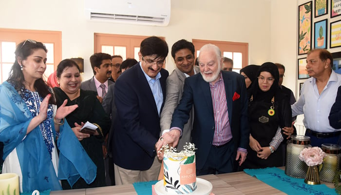 Sindh Chief Minister Syed Murad Ali Shah and former Senator Abdul Haseeb Khan and other cutting cake seen in this image released on September 14, 2024. — Facebook/@SindhCMHouse