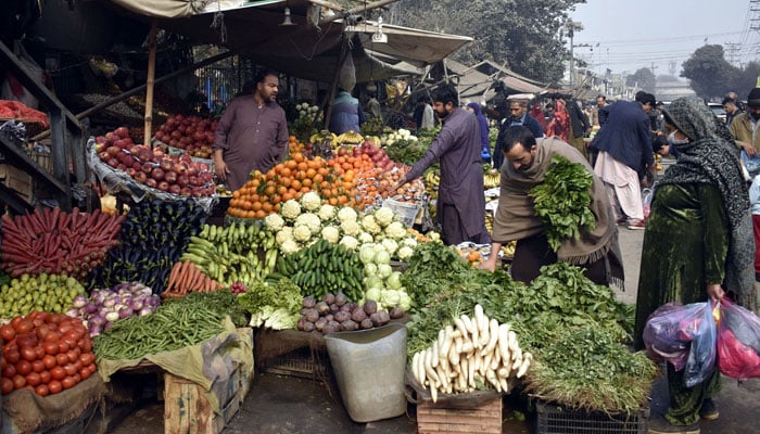 People buy vegetables in front of Kotwali Police Station in Lahore on January 28, 2024. — Online