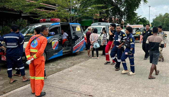 Volunteers and rescue workers stand beside vehicles transporting relief supplies to flood-affected areas in Myanmars Bago region on September 15, 2024. — AFP