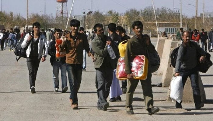 A group of Afghan migrant workers enter Afghan territory after leaving Iran at the Islam Qala border in Herat province. — Reuters/File