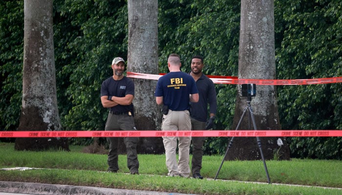 Law enforcement personnel investigate the area around Trump International Golf Club after an apparent assassination attempt of former President Donald Trump on September 15, 2024 in West Palm Beach, Florida. — AFP