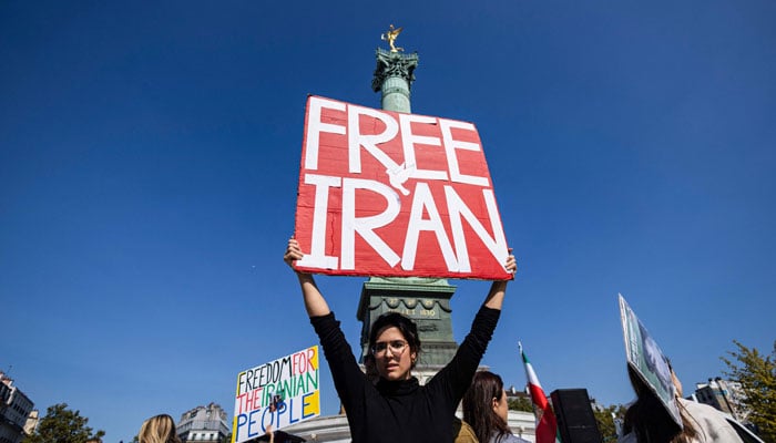 A protester holds a placard as she takes part in a march on the second anniversary of a protest movement sparked by the death in custody of Mahsa Amini, 22, arrested for allegedly violating the dress code for women at Place de la Bastille, in Paris on September 15, 2024. — AFP