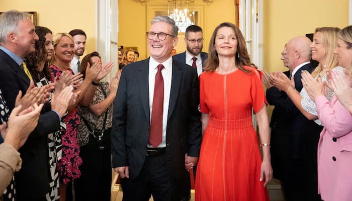 UK Prime Minister Sir Keir Starmer and his wife Victoria Starmer are clapped in by staff as they enter his official London residence at No 10 Downing Street for the first time after the Labour Party won a landslide victory at the 2024 General Election, in London, Britain, July 5, 2024. — Reuters