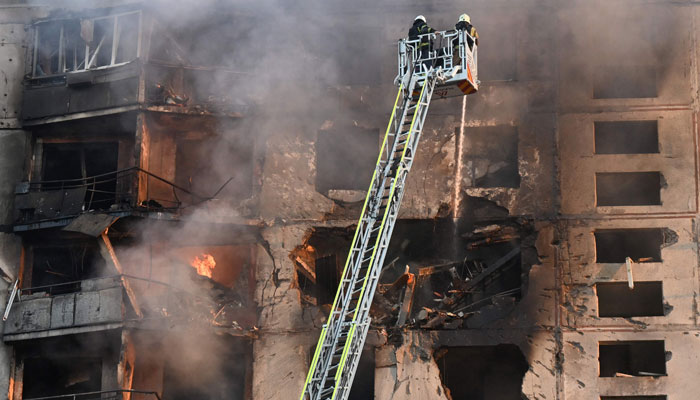 Ukrainian rescuers work to extinguish a fire in a residential building following a missile attack in Kharkiv on September 15, 2024. — AFP