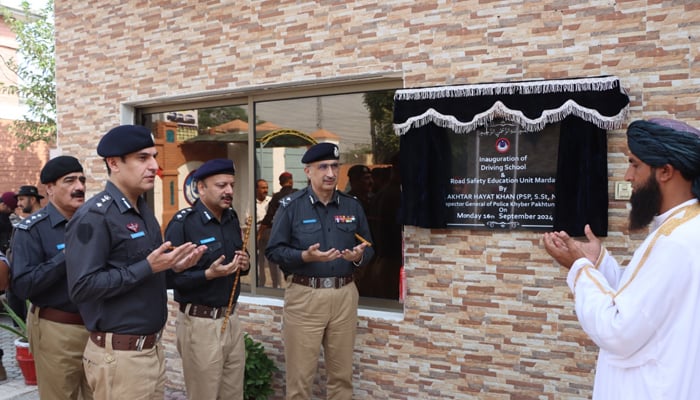 Inspector General of Police (IGP) Akhtar Hayat Gandapur prays with the policemen after inaugurating residential quarters, road safety and education unit image released on September 9, 2024. — Facebook/@pakhtunkhwapolice