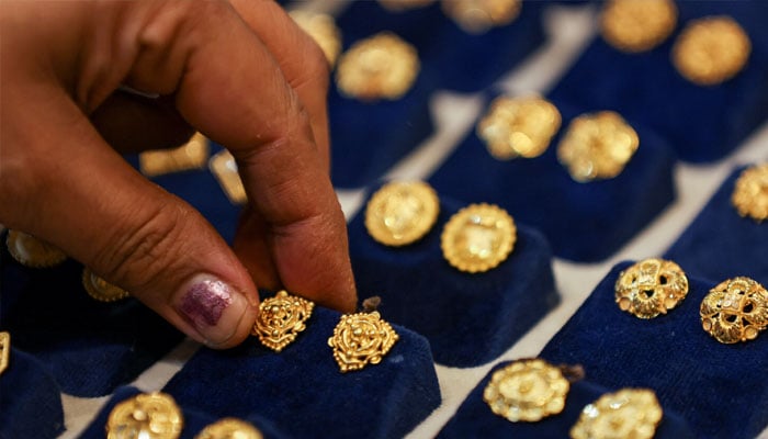 A jeweller waits for a customers at a shop in Karachi on June 26, 2024. — AFP