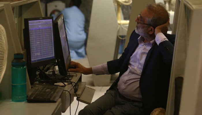 A Pakistani stock-broker monitors shares prices at the Pakistan Stock Exchange on January 16, 2023. —INP