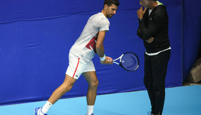 Italian fitness coach Marco Panichi (R) working with Serbias Novak Djokovic during the 2022 Tel Aviv Open. — AFP/file