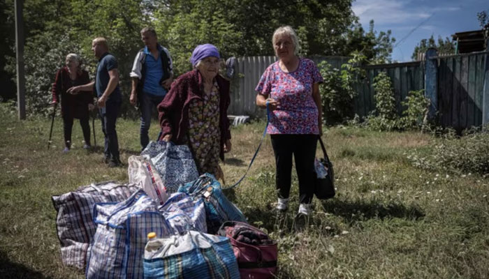 Local residents from a village near the Russian border wait for buses for an evacuation to Sumy due to Russian shelling, amid Russias attack on Ukraine, in Sumy region, Ukraine August 9, 2024. — Reuters