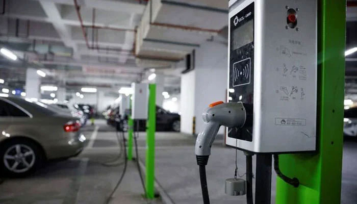 Representational image of an electric car charging in a parking lot on March 13, 2021. — Reuters