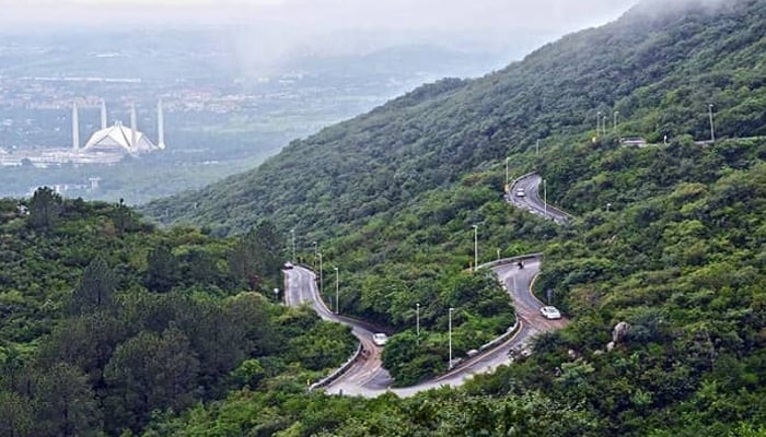 Pir Sohawa tourist resort is located on Margalla Hills near Islamabad. In this picture, trees can be seen along the paths and a beautiful view of Shah Faisal Masjid Islamabad can be seen in the distance. — flypakistan Website/File