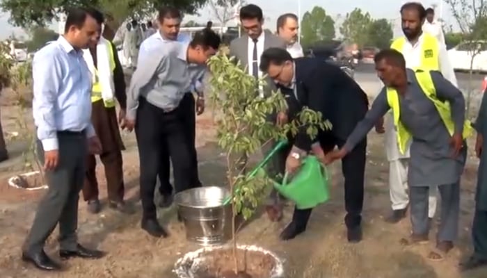 Attock Petroleum Limited (APL) and Capital Development Authority (CDA) officials are watering in the plant after planting can be seen in this image released on September 16, 2024. —  Screengrab/Facebook/@apl.com.pk