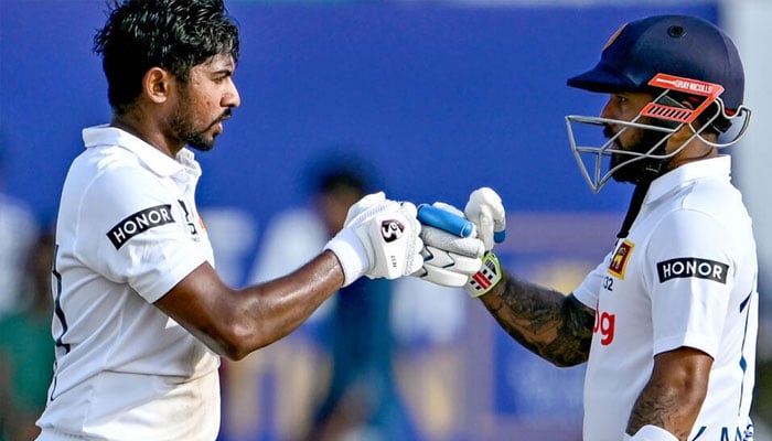 Sri Lanka’s Kamindu Mendis (left) celebrates with Kusal Mendis after scoring a century on the first day of the first Test against New Zealand. — AFP/file