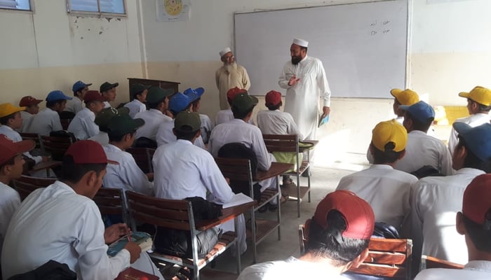 District Education Officer (male), Lower Dir, Inayatullah Khan talking to the school children seen in this image released on September 18, 2024. — Facebook/@GHS Dherai Talash lower Dir