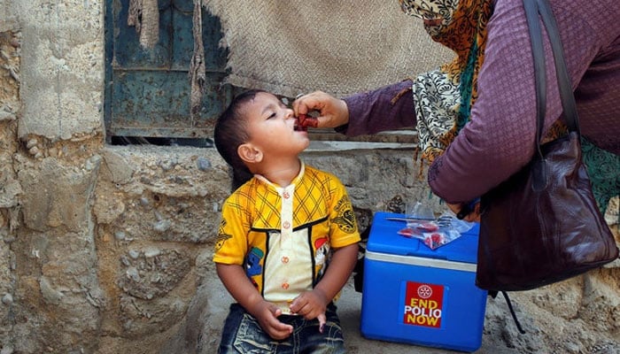 A boy receives polio vaccine drops during an anti-polio campaign in a low-income neighborhood in Karachi, Pakistan, on April 9, 2018. — Reuters