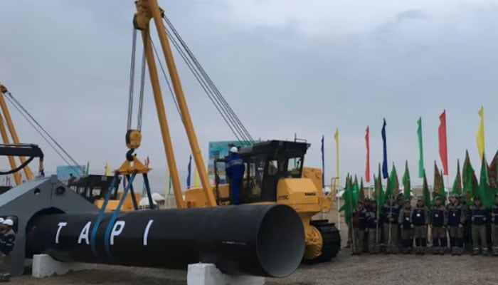 Representational image shows workers standing near the Tapi gas pipeline. — Reuters/File