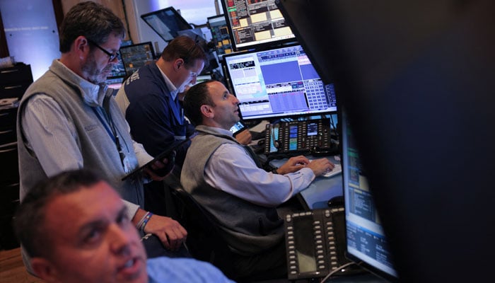 Traders work on the trading floor at The New York Stock Exchange (NYSE) following the Federal Reserve rate announcement, in New York City, US, September 18, 2024. — Reuters