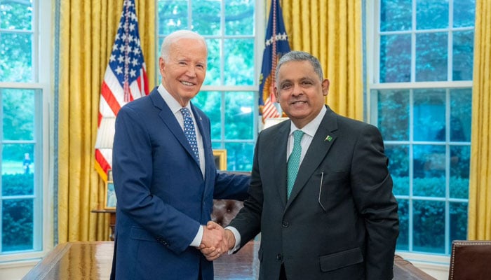 US President Joe Biden (left) shakes hand with Pakistans Ambassador Rizwan Saeed Sheikh. — Supplied/File