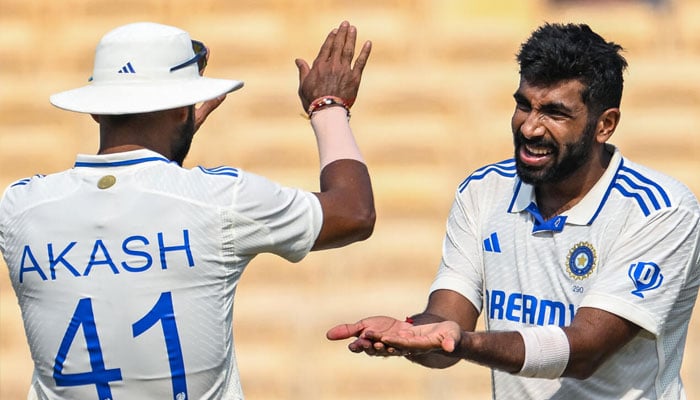 Indias Jasprit Bumrah (R) celebrates with Akash Deep after taking the wicket of Bangladeshs Taskin Ahmed during the second day of the first Test cricket match in Chennai on September 20, 2024. — AFP