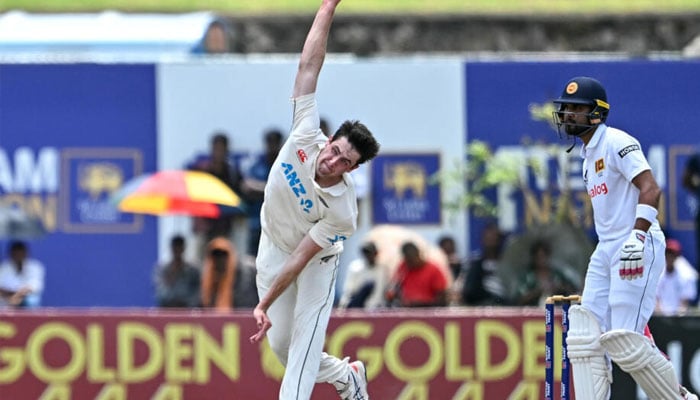 New Zealands William ORourke bowls as Sri Lankas Dinesh Chandimal watches during the third day of the first Test cricket match in Galle.— AFP