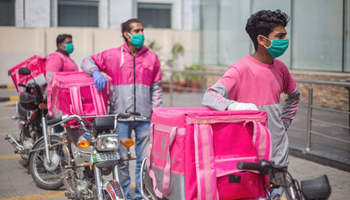 The representational image shows Foodpanda riders standing alongside the road. — Foodpanda Website/File