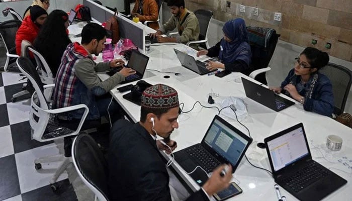 A representational image of a companys employees talking with customers at a call centre in Lahore, Pakistan. — AFP/File