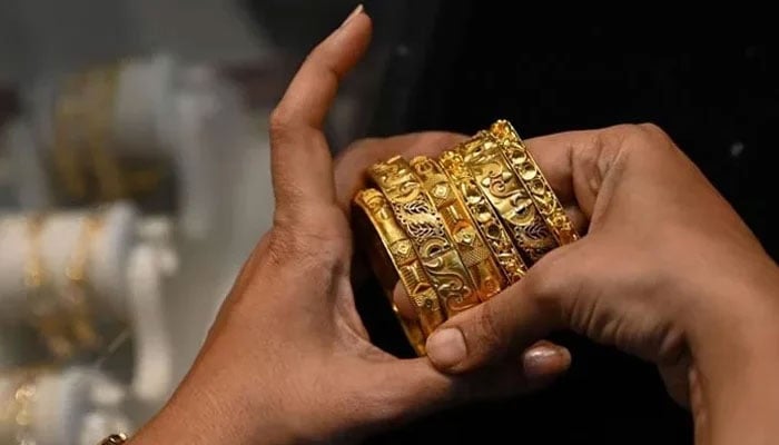 An undated file image of a woman wearing gold bangles. — AFP