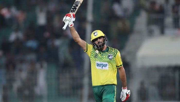 Nurpur Lions’ Muhammad Irfan Khan raises his bat after scoring century in the Bahria Town Champions One-Day Cup at Iqbal Stadium, Faisalabad— PCB