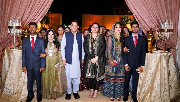 Child Protection Bureau (CPB) Chairperson Sarah Ahmad (centre) pose for a photo along with two couples who tied the knot at a wedding ceremony, image released on September 21, 20254. — Facebook/Sarah Ahmad