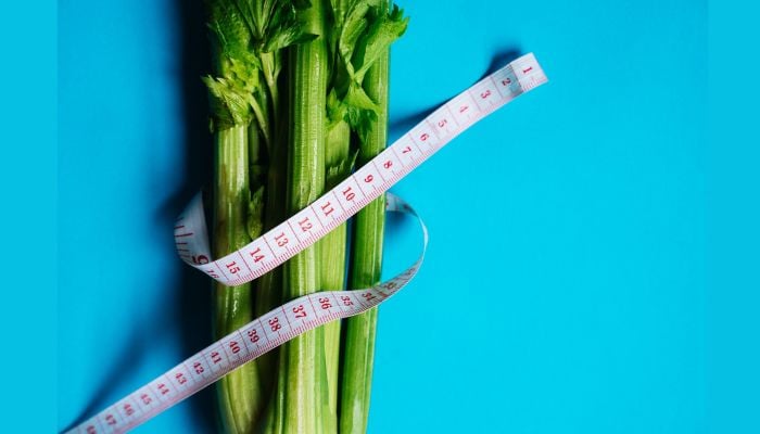 A bundle of celery wrapped with a measuring tape.— Pexels/File