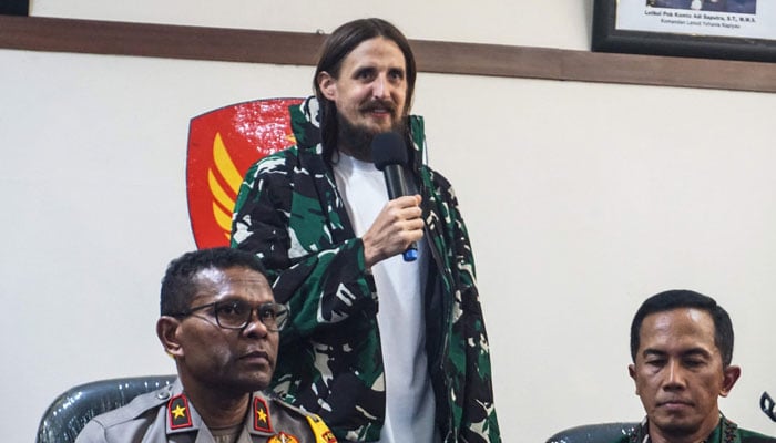 New Zealand pilot Phillip Mehrtens (C), who was snatched by rebels in Indonesias restive region of Papua in February last year, speaks during a press conference following his release in Timika, Central Papua on September 21, 2024. — AFP