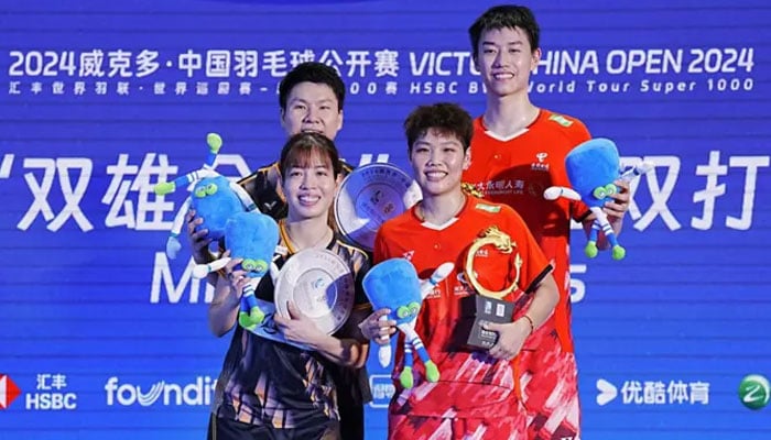 Gold medalists Chinas Feng Yan Zhe (back, right) and Huang Dongping celebrate on the podium with silver medalists Malaysias Goh Soon Huat (back, left) and Lai Shevon Jemie during an award ceremony for the mixed doubles final match at the China Open Badminton tournament in Changzhou, in Chinas eastern Jiangsu Province on Sunday on Sept 22, 2024. — AFP