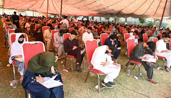 This image shows students attempting the MDCAT exam in the Khyber Medical University (KMU examination hall on September 22, 2024. — X/@kmuofficial_