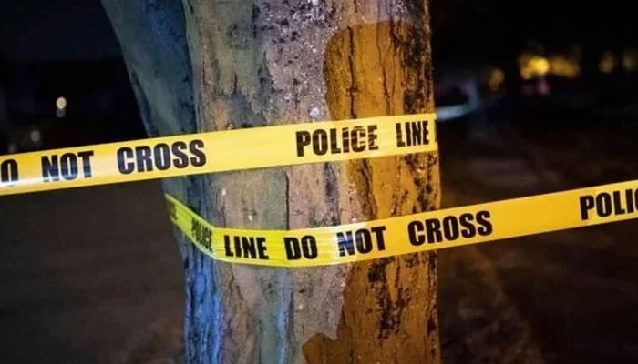 A representational image of a police tape wrapped on a tree at a murder & crime scene. — AFP/File