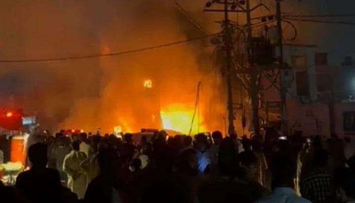 The scene of fire in a shop selling petrol and oil in Shah Faisal Colony No. 3 September 11, 2024. — Reporter