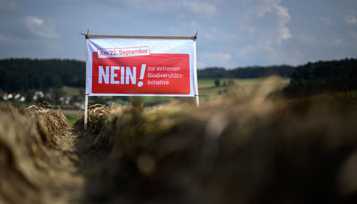 This photograph shows an electoral banner reading No ! To extreme biodiversity initiatives placed in a field by a farmer against a Swiss popular initiative on biodiversity in Hochstetten on August 31, 2024. — AFP