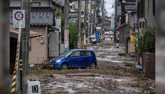 A stranded car is seen in a mud-covered road following heavy rain in Wajima city, Ishikawa prefecture on September 22, 2024. — AFP