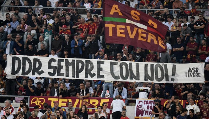 Roma supporters hold a banner reading Daniele De Rossi always with us during Sundays 3-0 win over Udinese. — AFP/file