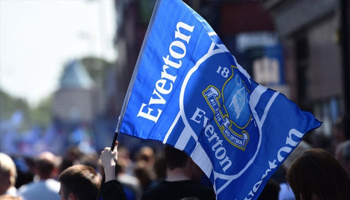 A person holding the Everton flag.— AFP/file