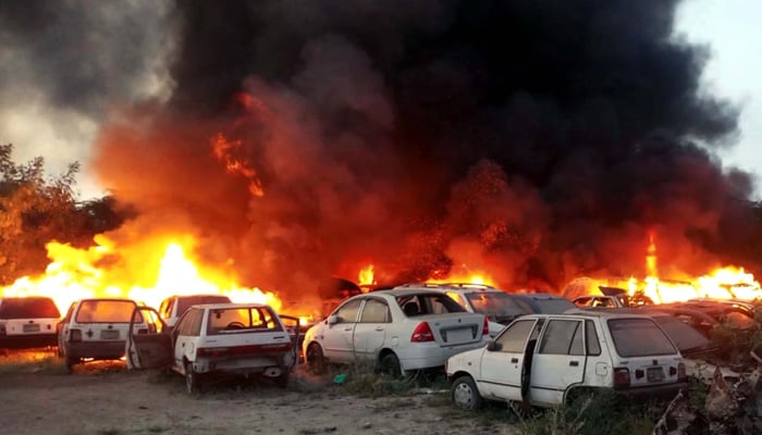 View of huge fire flames and dark smokes rise from burning vehicles after fire broke out incident near Qurtaba Mosque Clifton in Shireen Jinnah Colony in Karachi on September 23, 2024. — PPI