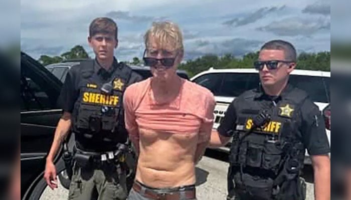 Law enforcement officers arrest Ryan Routh, the man suspected in the apparent assassination attempt of US presidential candidate Donald Trump on September 15, 2024. — Reuters