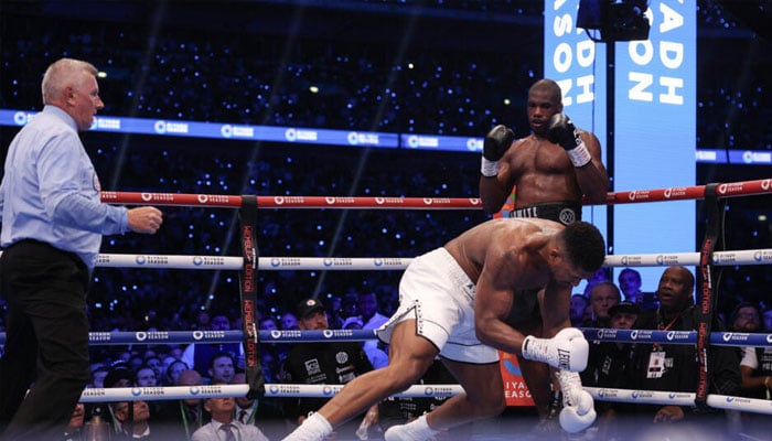 Anthony Joshua is knocked to the ground by Daniel Dubois during their IBF world title fight at Wembley.— AFP/file