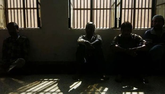 Representational image of Prisoners sitting inside a dark lockup are seen in this undated image. — AFP/File