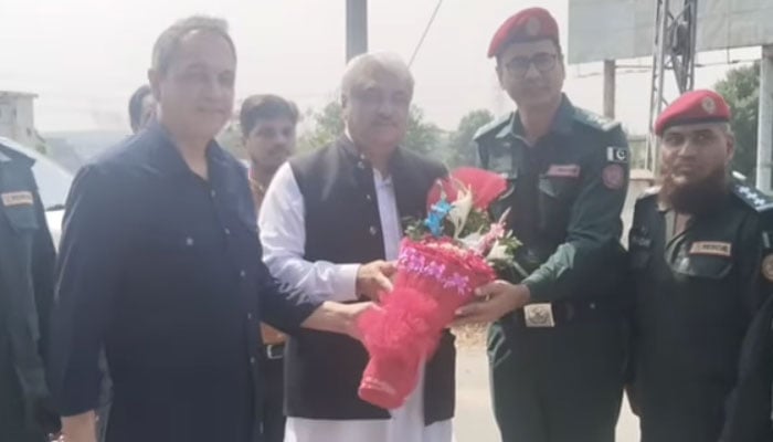 This screengrab taken on September 24, 2024, shows Secretary of Emergency Services Department Dr Rizwan Naseer (left) and other rescue officials presenting a flower bouquet to Provincial Minister of Health and Emergency Services Khawaja Salman Rafique during his visit to Motorway Interchange. — Facebook/Khawaja Salman Rafique